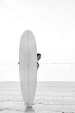 Young Smiling Brunette (girl, Woman) Looking Out, Standing Behind White Surfboard