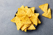 Nachos chips in bowl. Stone background. Top view.