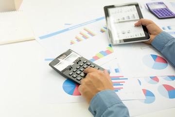 Businessman using a personal income tax calculator.