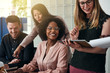 © Flamingo Images - Smiling group of diverse businesspeople working in an office