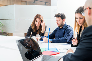 Group of young people employee workers with computer in urban alternative studio - Business concept of human resource and fun on working time - Start up entrepreneurs at office