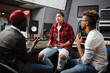 © pressmaster - Young deejays taking interview with one of popular musician in their studio