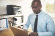 © Flamingo Images - African entrepreneur working online in a home office