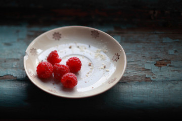 raspberry on a vintage plate