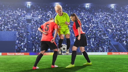 Wall Mural - three female soccer players during struggling for the ball