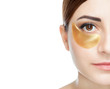 Collagen gold patches on the skin of the eyelid, on the face of a beautiful woman.
