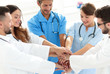 © ASDF - Doctors and nurses stacking hands. concept of mutual aid.