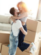© ASDF - Hugging couple, against the background of boxes