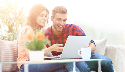 Wall Mural - young couple looking at a laptop screen