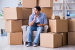 © Elnur - Young man moving in to new house with boxes