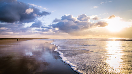 Walking along the beach during sunset in IJmuiden the Netherlands,