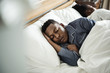 © Rawpixel.com - A man sleeping soundly in bed