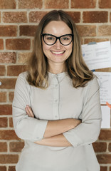 Wall Mural - Portrait of Caucasian woman against brick wall