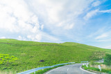 Fototapeta Tęcza - Beautiful  landscape view of  a country road and green grass with  blue sky  background of Utsukushigahara park is  one of the most important and popular natural place in Nagano Prefecture , Japan.