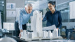 © Gorodenkoff - In the Architectural Bureau Two Professional Engineers Work on a Model of a City District. Urban Planners Work on a Functional Building Model.