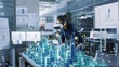 © Gorodenkoff - Professional Female Architect Wearing Makes Gestures with Augmented Reality Headset, Shows Statistics for 3D City Model. High Tech Office Use Virtual Reality Modeling Software Application.