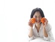 © Mallika - Young Asian woman holding salad bowl and fresh fruit,she's happy and joyful with this meal in the morning.