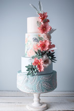 Wedding Four-tiered Cake Decorated With Spring Red Flowers And Handmade Pattern. Concept Of Delicious Desserts