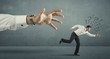© ra2 studio - Businessman running away from a big hand