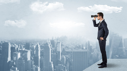 man looking forward from the top of a skyscraper