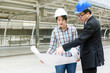 © Worapoj - Engineer talking about construction plan with team.