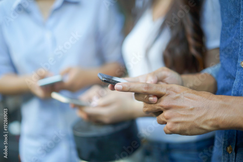 Cuadros en Lienzo close up focus man hand hold smart phone device for work and play application feature with friends ,lifestyle of innovation technology concept