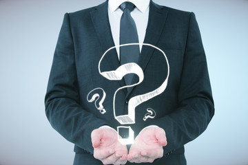 Fototapete - Businessman holding question marks