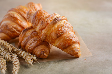 Fresh Croissants on brown concrete background Selective focus Copy space