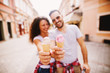 © Dusan Petkovic - Photo of ice creams in cones held by cute couple in the city.
