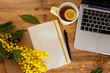 © Mary Abramkina - cup of tea notebook, laptop, flowers on a wooden background