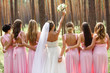 © Wedding photography - Bride and bridesmaids in pink dresses having fun at wedding day. Happy marriage and wedding party concept
