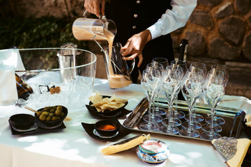 Waiters are serving vine at a wedding outdoor party