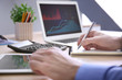 © Africa Studio - Man working at table in office, closeup. Financial trading concept