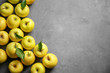 Ripe yellow apples on grey background