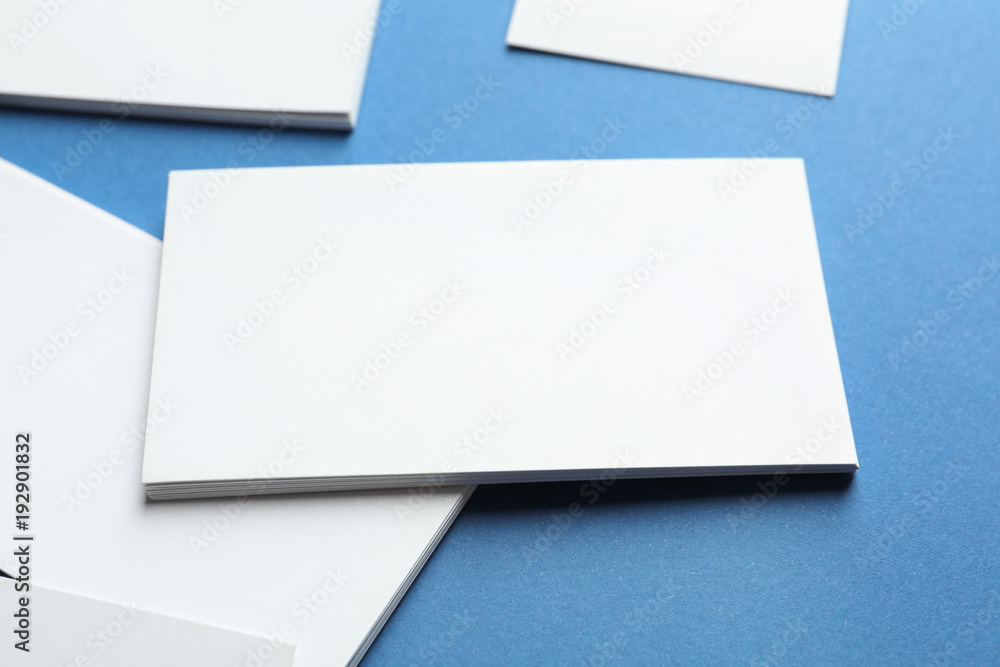 Blank business cards on color background