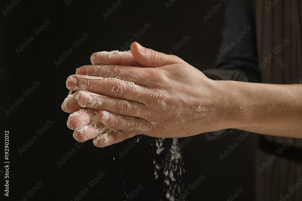 Woman with flour on black background