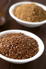 Poster - Whole brown flax seeds or linseeds and ground linseeds in small bowl, photographed on dark wood with natural light (Selective Focus, Focus one third into the image)