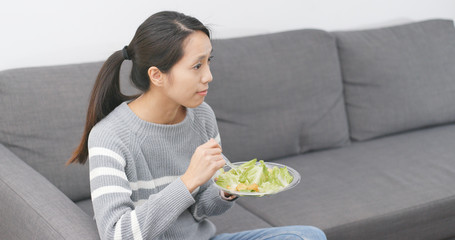 Wall Mural - Woman eating salad at home