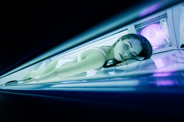 Wall Mural - Beautiful woman tanning in solarium