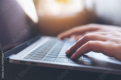 Cuadros en Lienzo Closeup image of hands working and typing on laptop keyboard on the table