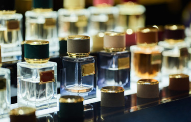 many different perfums in a store on the market