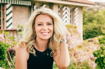 Wall Mural - outdoor portrait of beautiful blond woman resting outdoors