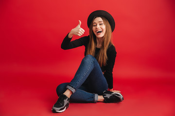 Wall Mural - Portrait of a smiling stylish girl wearing hat