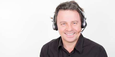 Poster - Smiling businessman talking on headset against a white background