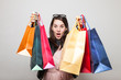 © jev - Surprised modern woman goes shopping on a christmas sale