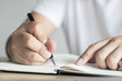 © khwanchai - writing, knowledge and learning concept, hand of man recording information on notebook.