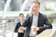 © Nattanon - Smsrt businessman is using his mobile talk business.