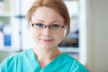 Smiling nurse with glasses