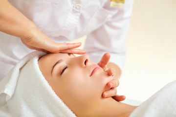 Wall Mural - beautiful woman at a facial massage at a spa salon.