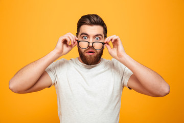 Wall Mural - Portrait of a surprised bearded man in eyeglasses